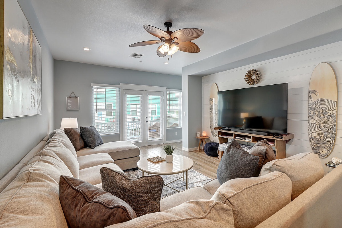 Sink into plush sectional seating while your favorite shows play on the big screen. Coastal-themed decor and warm lighting create your perfect retreat.