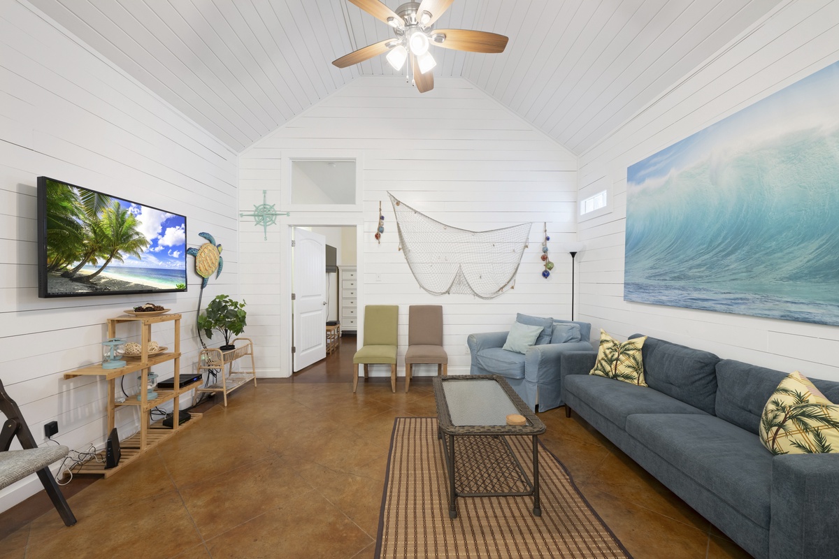 Sink into plush coastal comfort in your airy living space, where beach-inspired decor, vaulted ceilings, and tropical touches invite you to unwind after sun-soaked adventures.