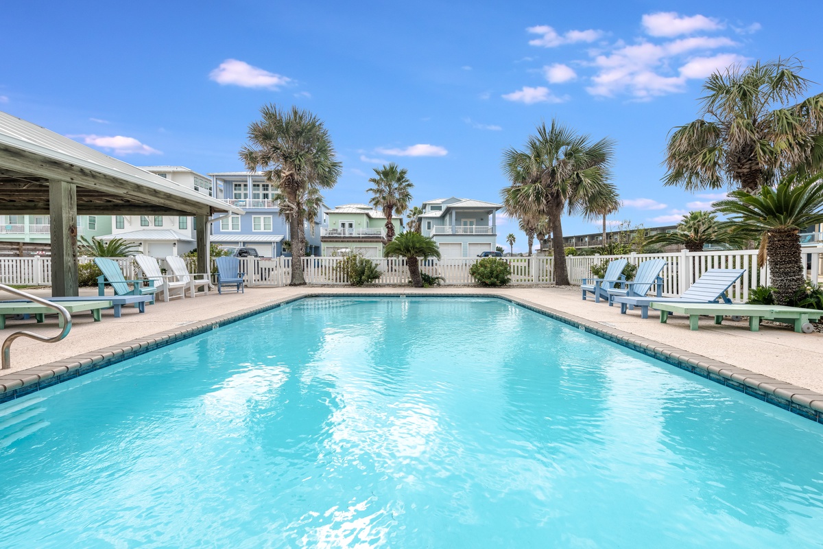 Dive into crystal-clear waters while palm trees sway overhead. Your perfect poolside retreat awaits with comfortable loungers and tropical vibes.