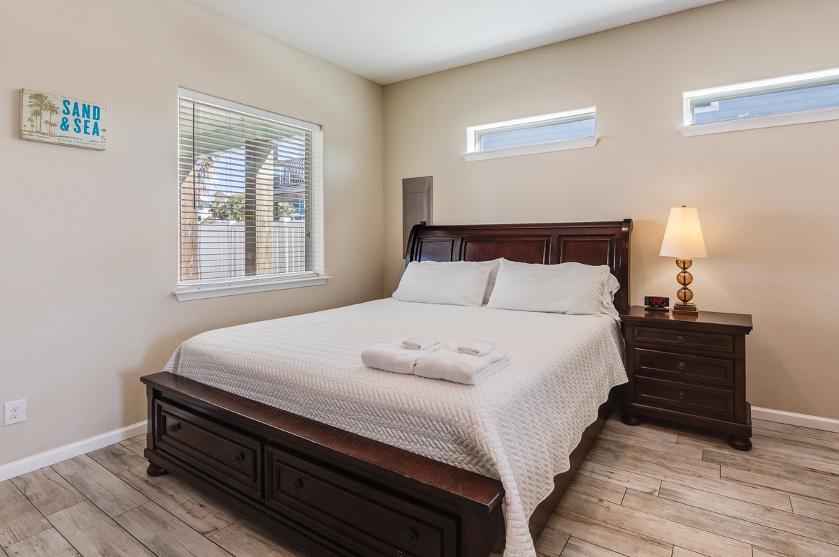 Your peaceful bedroom retreat features a plush queen bed with crisp linens and fluffy towels, perfect for unwinding after beach adventures.