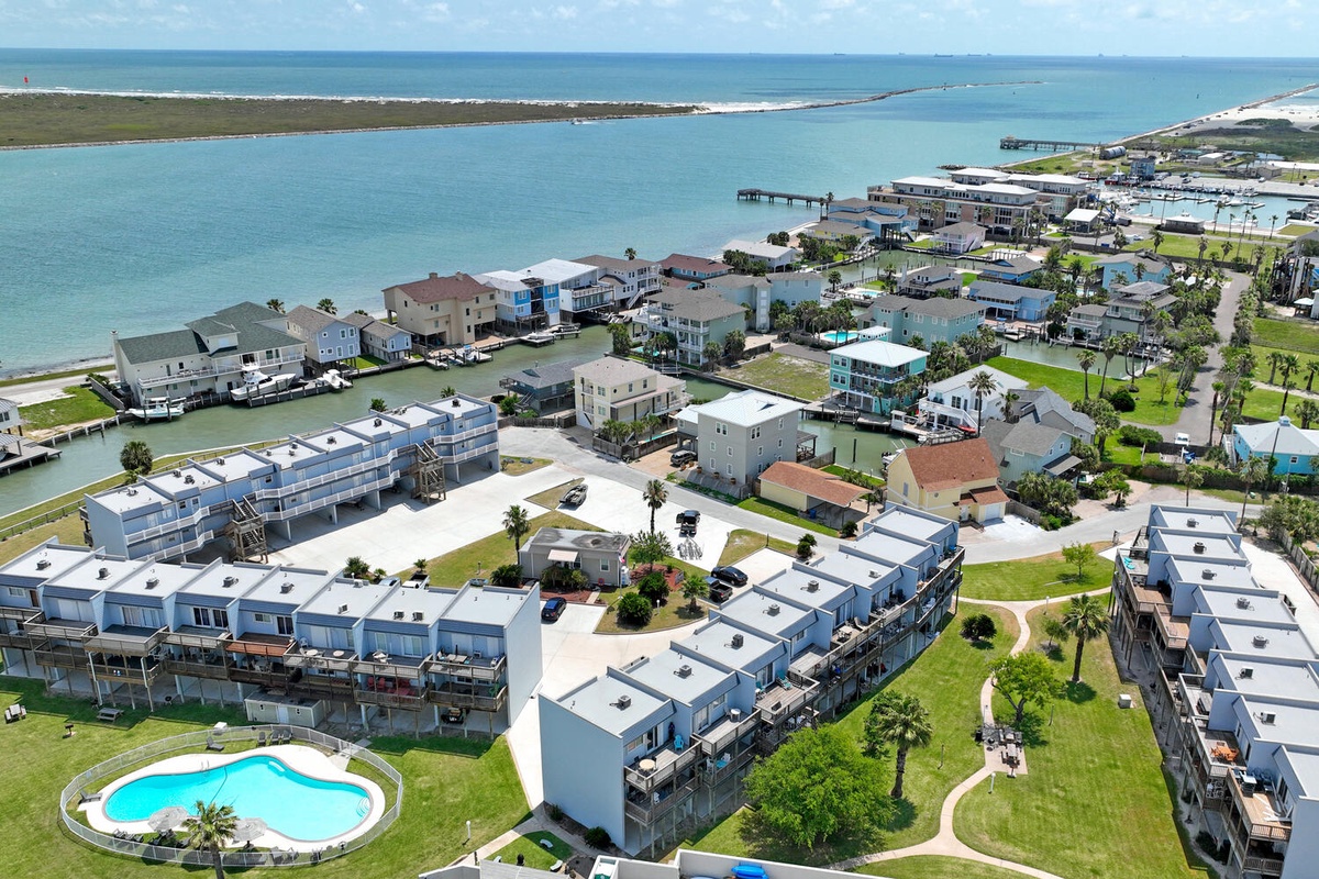 Modern waterfront community featuring contemporary condominiums with direct access to pristine blue waters and recreational boating facilities.
