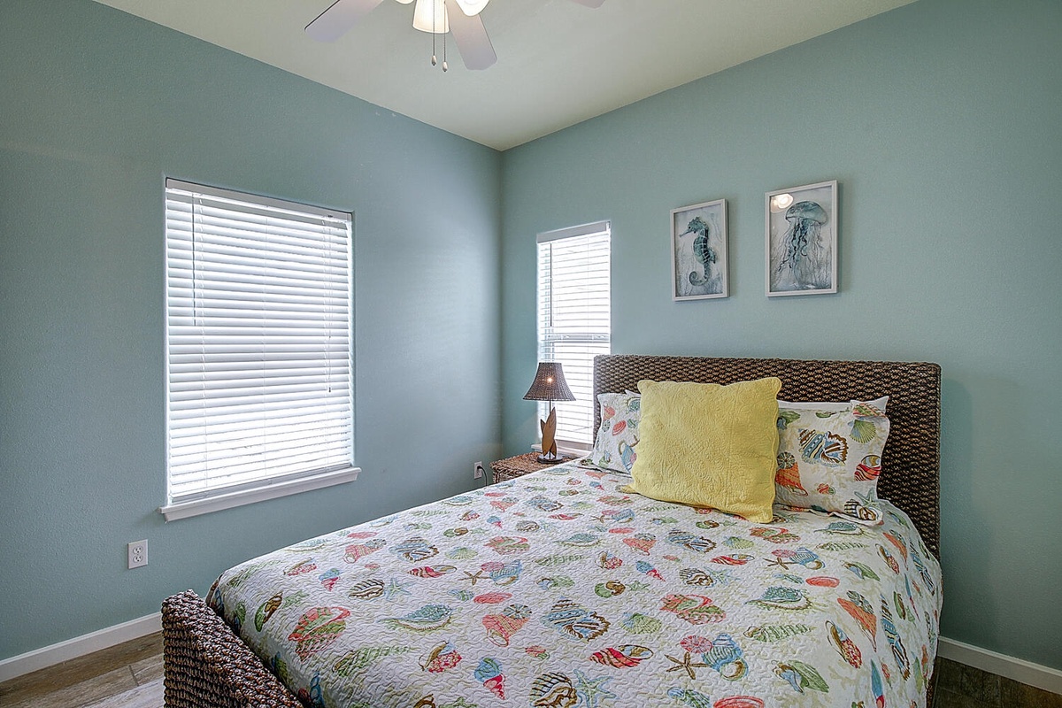 Wake up refreshed in your cozy coastal bedroom, where sea-foam walls and ocean artwork create your perfect seaside sanctuary.