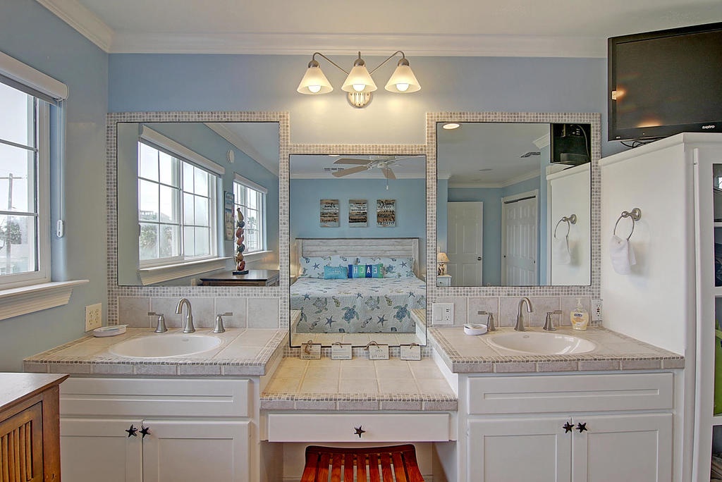 Your spa-like bathroom features dual vanities and elegant tile work for a refreshing morning routine.