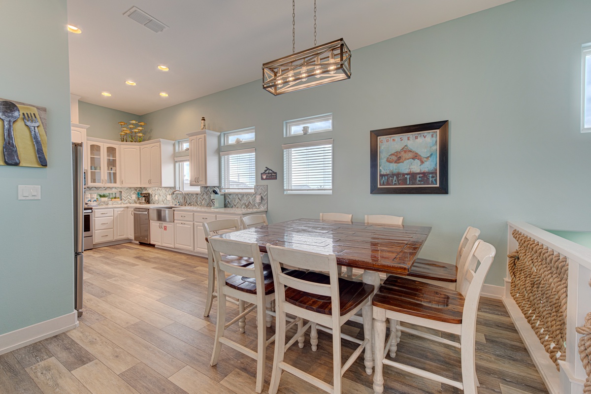 Gather around your beautiful farmhouse dining table in this open kitchen space, where soft mint walls and rustic charm create the perfect backdrop for memorable meals.