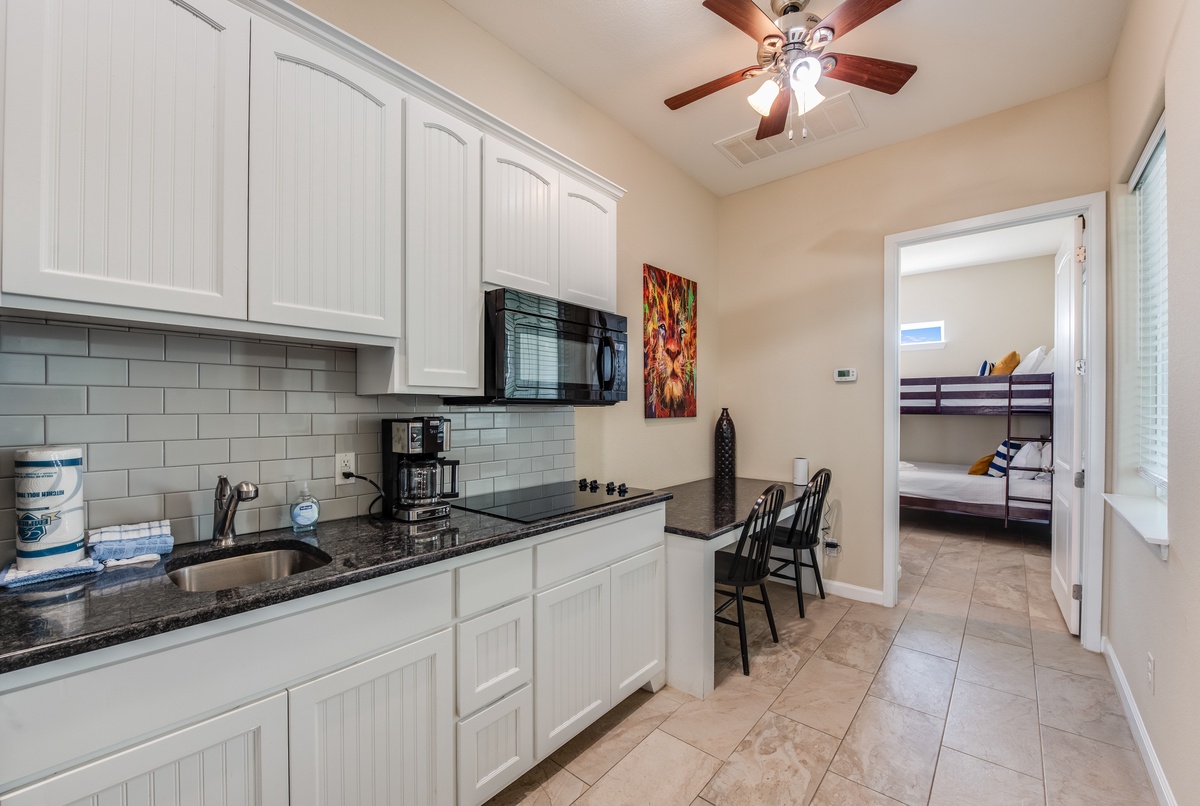 Your fully equipped kitchen awaits with granite counters, modern appliances, and everything needed for memorable family meals.
