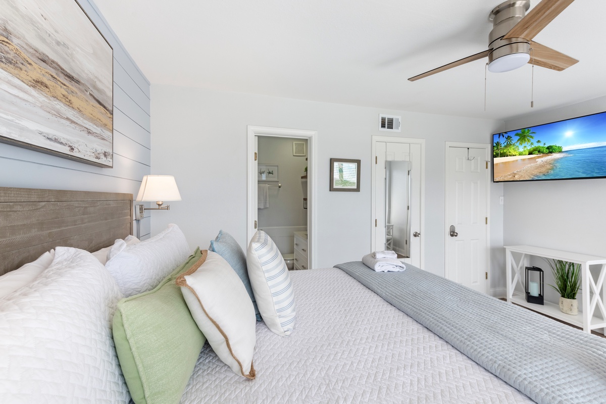 Unwind in your coastal-inspired bedroom with crisp linens, tropical touches, and your own wall-mounted TV for relaxing evenings.