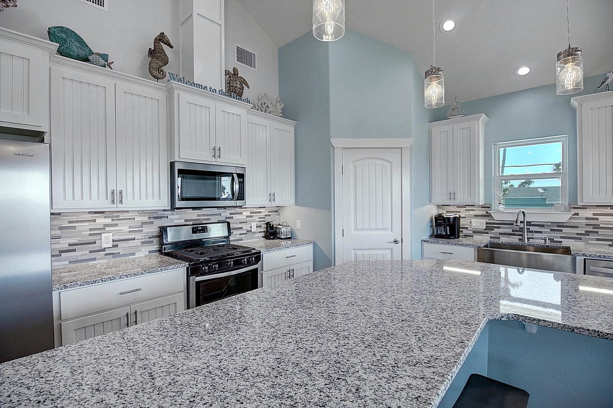 Your coastal-themed kitchen awaits with granite countertops, stainless appliances, and charming beachy touches for memorable meal prep.