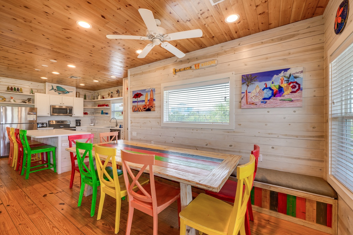 Gather around this vibrant dining table where colorful chairs invite laughter and memories over every meal in this cheerful space.