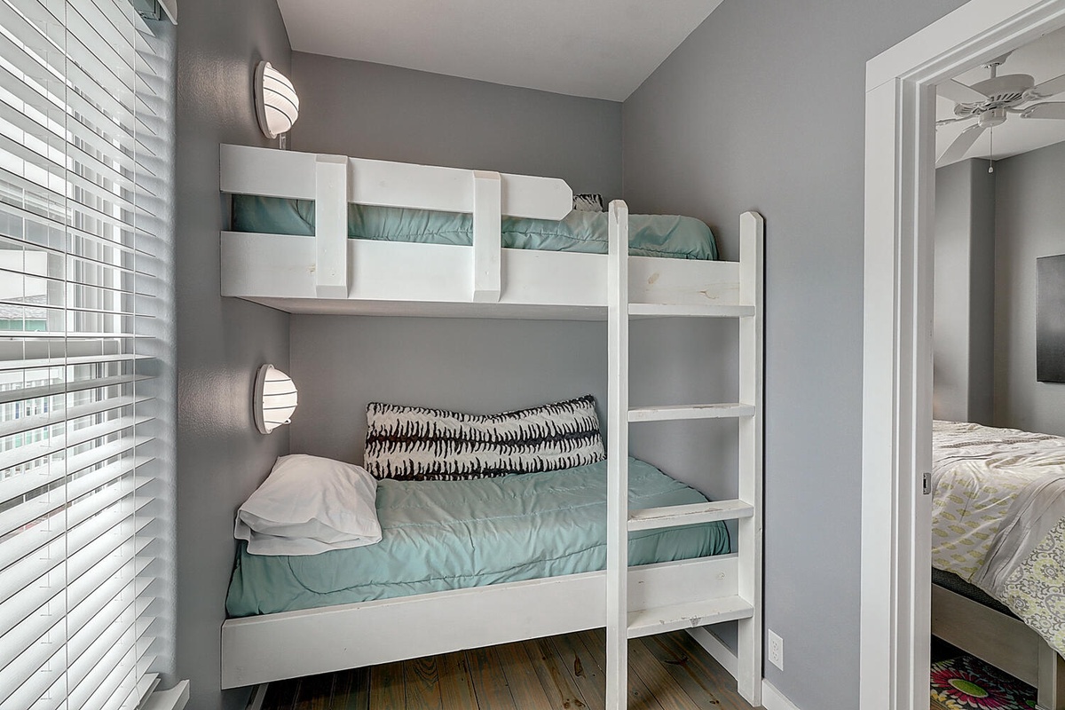 Sleep soundly in your cozy bunk beds, complete with reading lights and soft turquoise linens for a restful night.