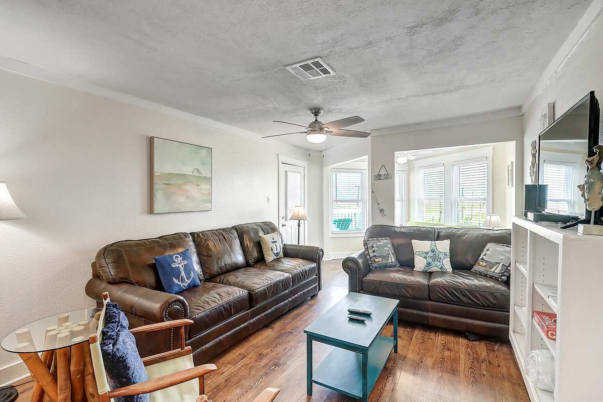 Sink into plush leather sofas and catch up on your favorite shows. Natural light fills this comfortable space for relaxing after beach days.