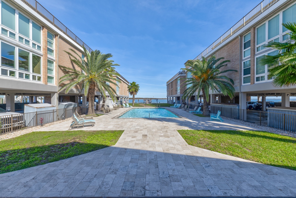 Step into your tropical paradise where crystal-clear pool waters meet swaying palms and endless ocean views await just beyond.