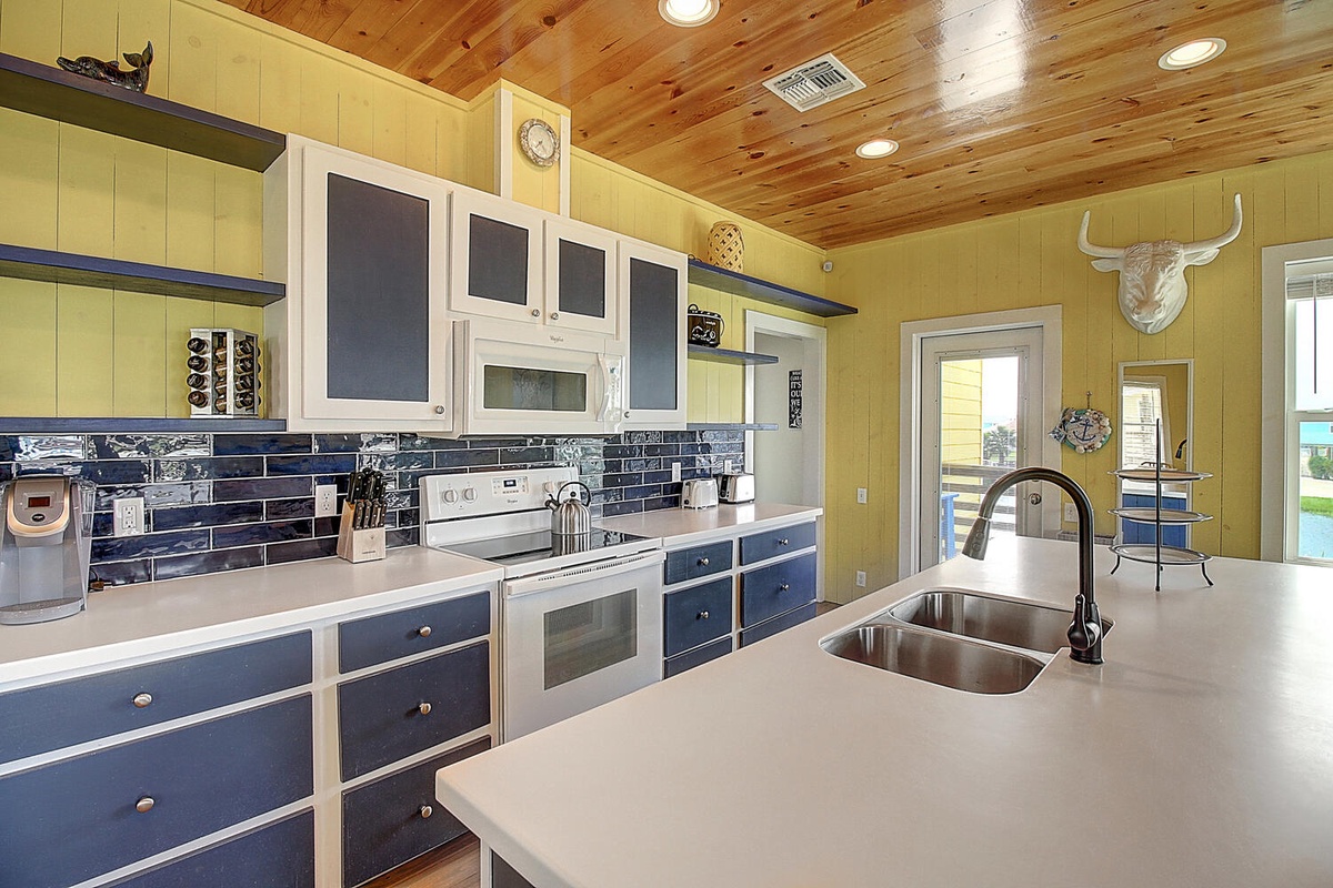 Your spacious kitchen features modern appliances, sleek countertops, and rustic wood ceiling charm for memorable meal prep.