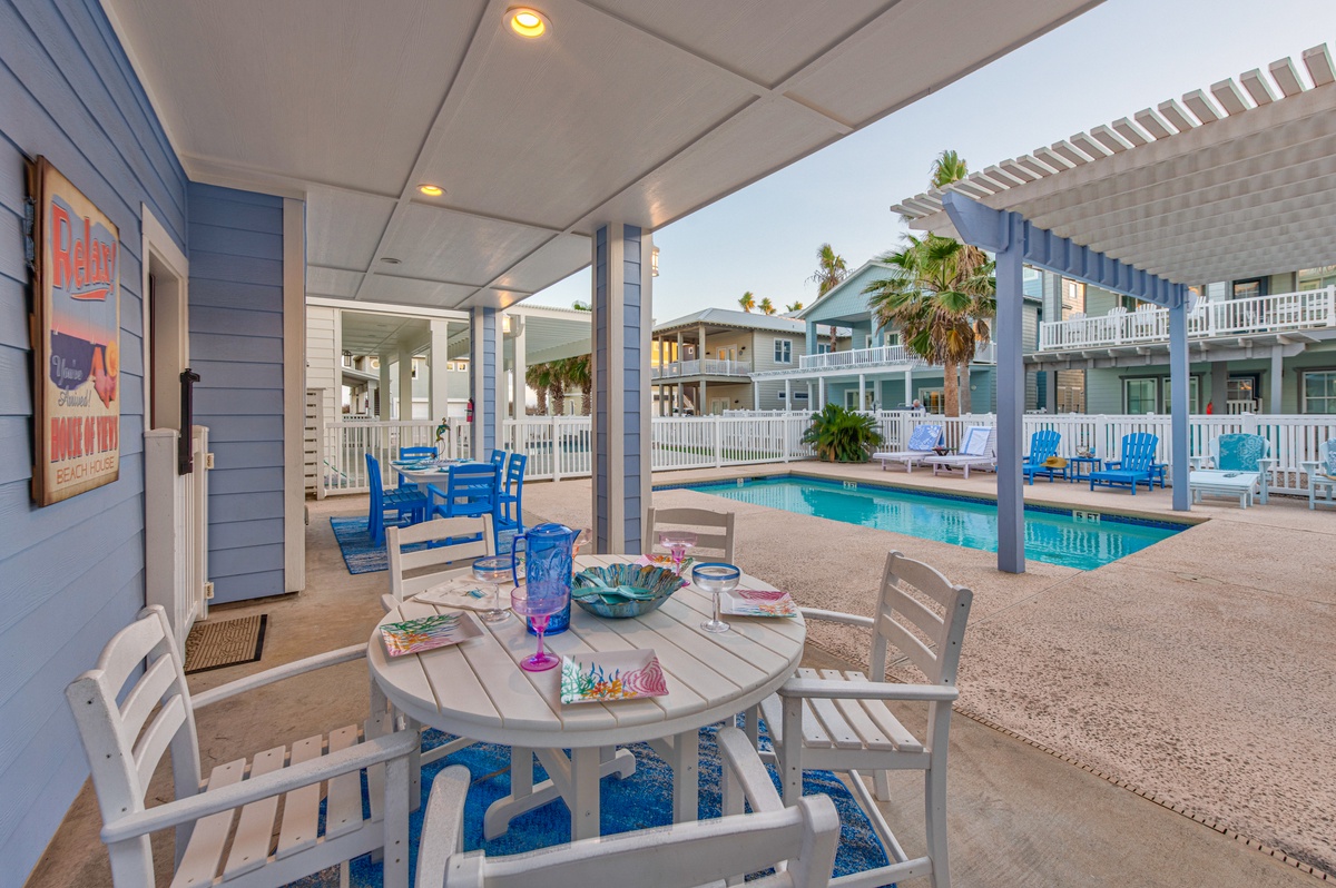 Your covered patio overlooks the sparkling pool, where you'll savor morning coffee and evening cocktails in this breezy coastal retreat.