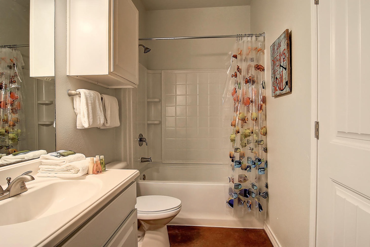 Refresh in your private bathroom featuring a deep soaking tub, fresh towels, and cheerful touches that make daily routines feel special.