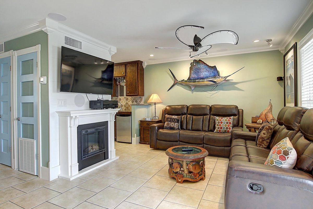 Sink into plush leather recliners by your warming fireplace, where coastal decor and modern comforts create your perfect retreat.