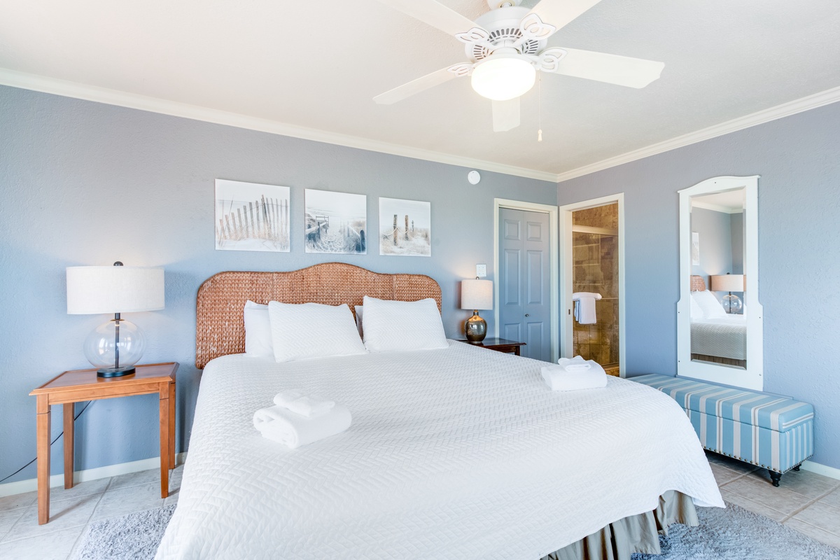 Sink into your comfortable bed surrounded by soothing coastal blues and warm wicker touches in this tranquil bedroom retreat.
