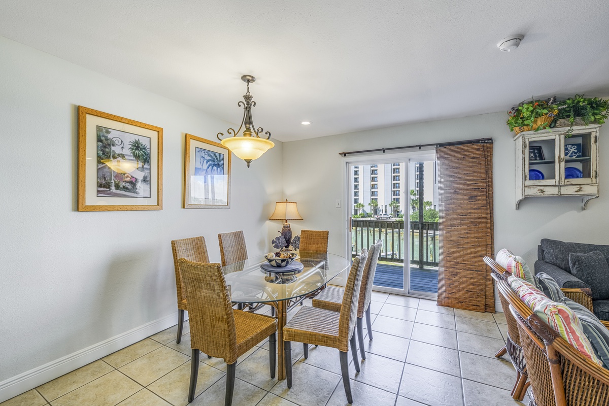 Gather around your elegant dining table for memorable meals, with wicker chairs and warm lighting creating the perfect atmosphere for conversation.