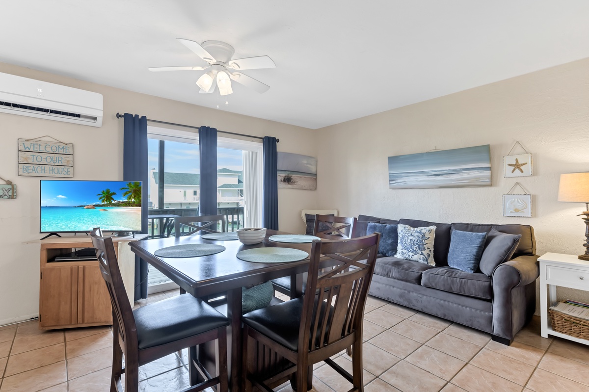 Relax in your coastal-themed living space with comfortable seating, dining for six, and beachy artwork setting the perfect vacation mood.
