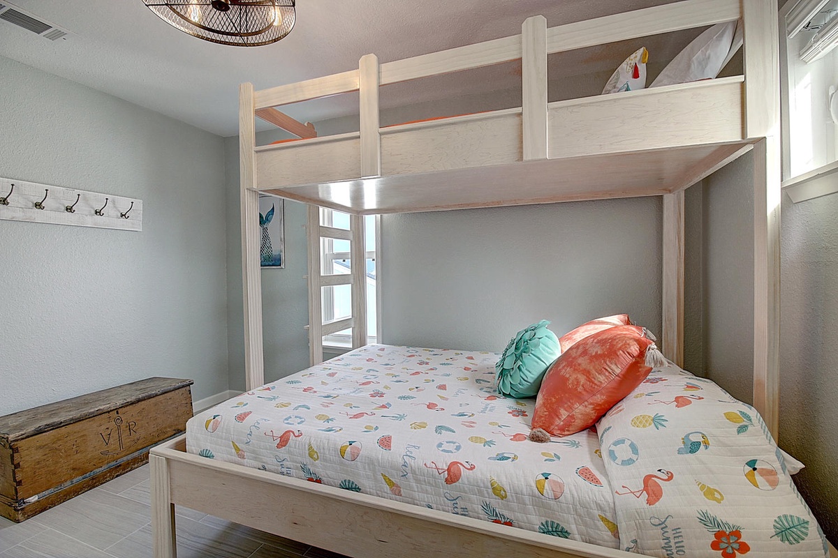 Your beachside bunk bed features cheerful tropical linens and colorful pillows, perfect for cozy nights after sun-soaked days.