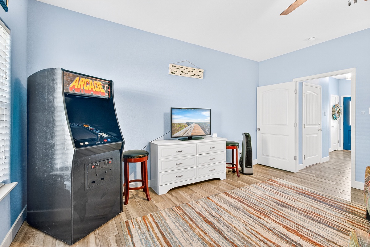 Challenge friends to arcade games in your private entertainment room, complete with classic machine and flat-screen TV for endless fun.