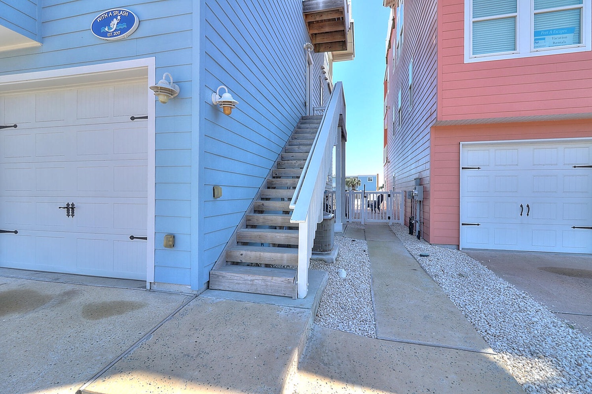 Charming beach-style townhomes with private garage access and coastal architecture in a sunny seaside community.