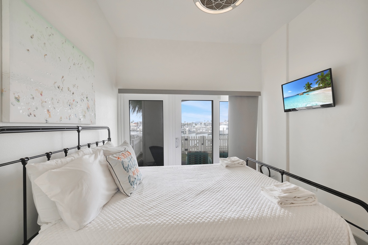 Relax in your stylish bedroom featuring crisp linens, city views, and modern amenities for the perfect getaway.