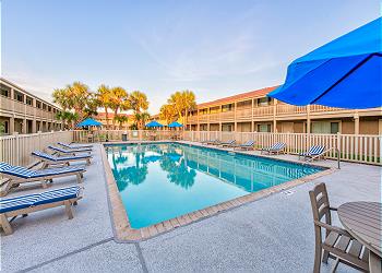 Dive into crystal-clear waters surrounded by comfortable loungers and swaying palms in this peaceful poolside paradise.