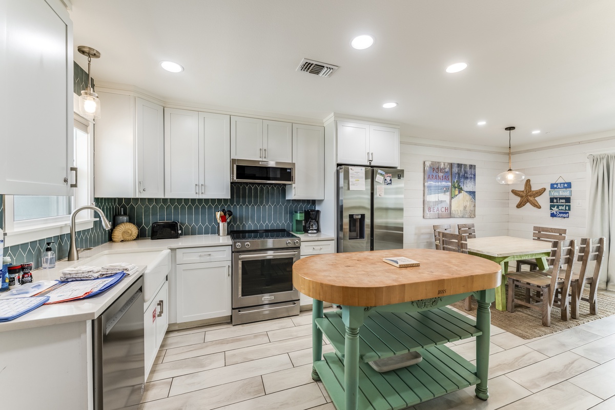 Gather around the spacious kitchen island and cook together in your beachy home away from home. Modern appliances, ample counter space, and coastal charm make meal prep effortless and fun.