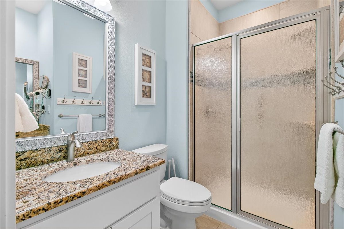 Relax in your beautifully appointed bathroom with granite countertops, elegant finishes, and a spacious glass shower for your comfort.