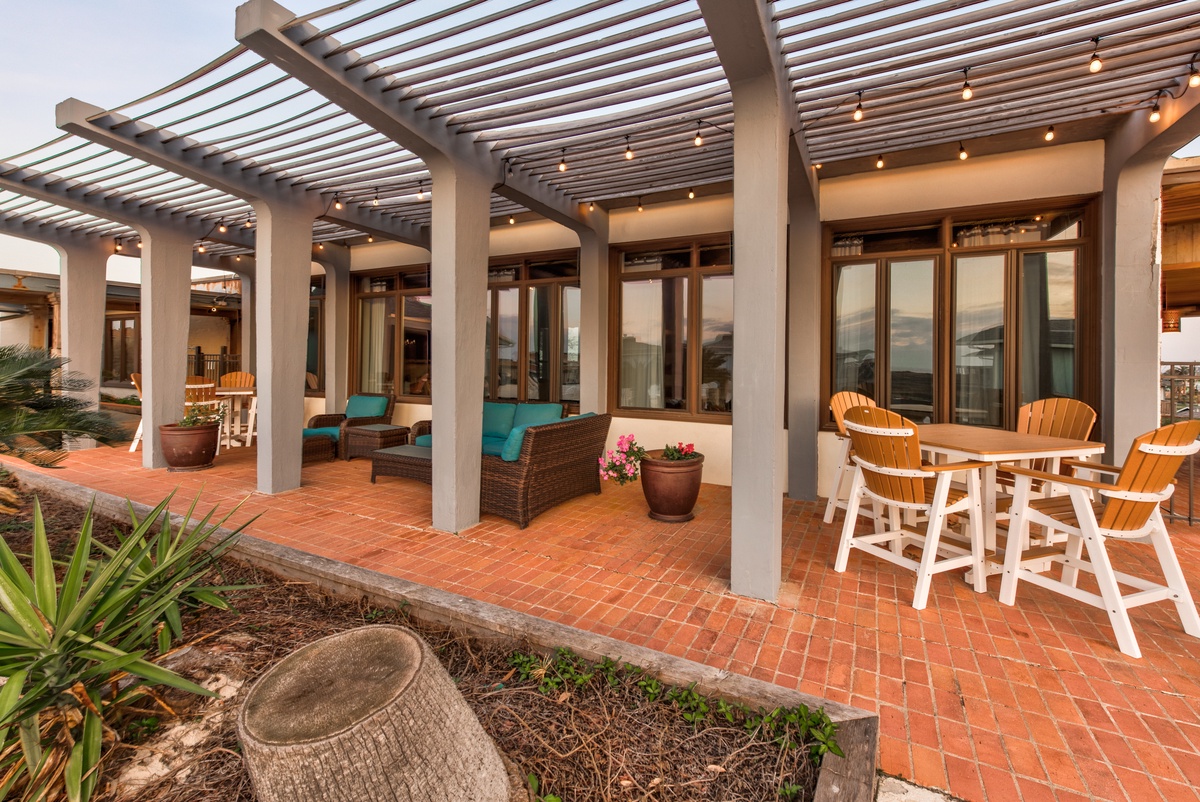 Your private covered terrace invites evening relaxation with twinkling lights overhead and comfortable seating perfect for morning coffee or sunset dining.