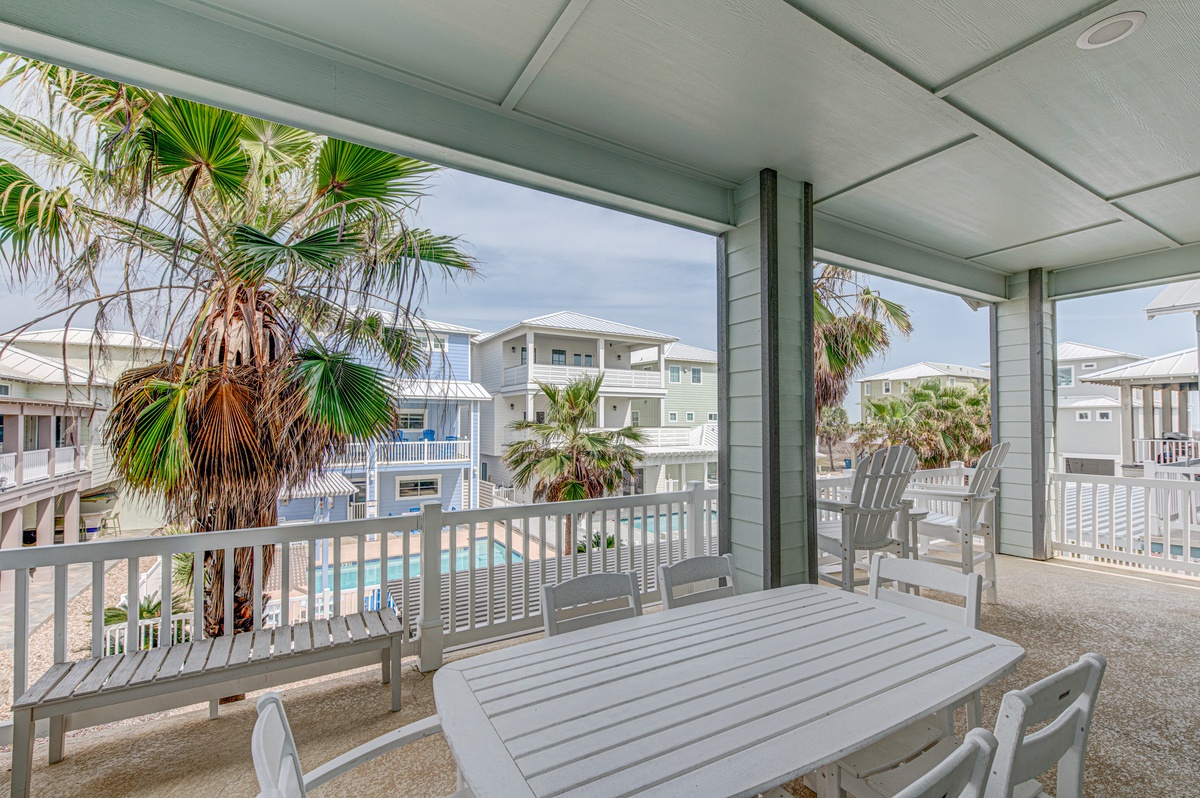 Sip your morning coffee on this breezy covered terrace, where tropical palms frame your view of the sparkling pool below.