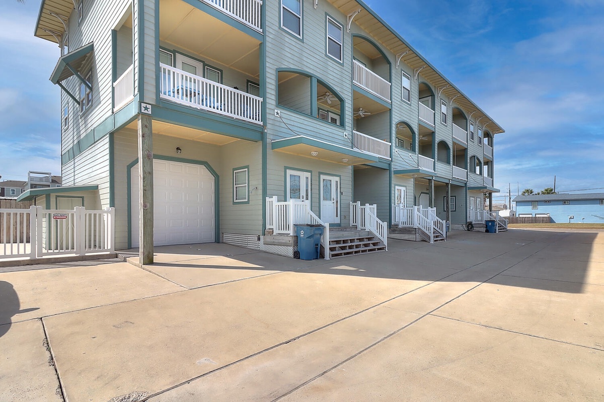 Multi-level coastal property featuring covered parking and private balconies in a serene beachside neighborhood.