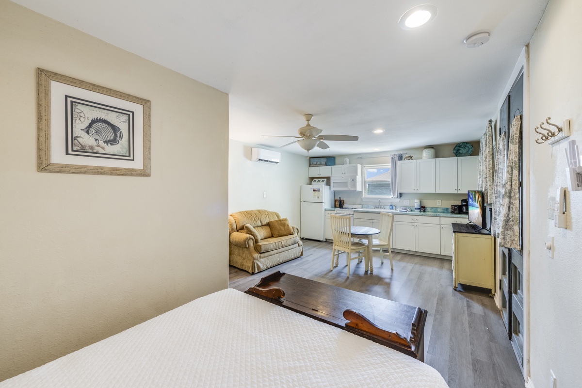 Your bright, open studio blends cozy comfort with practical living—relax in the plush armchair, whip up meals in your well-equipped kitchen, and unwind on your inviting bed after a day of adventure.