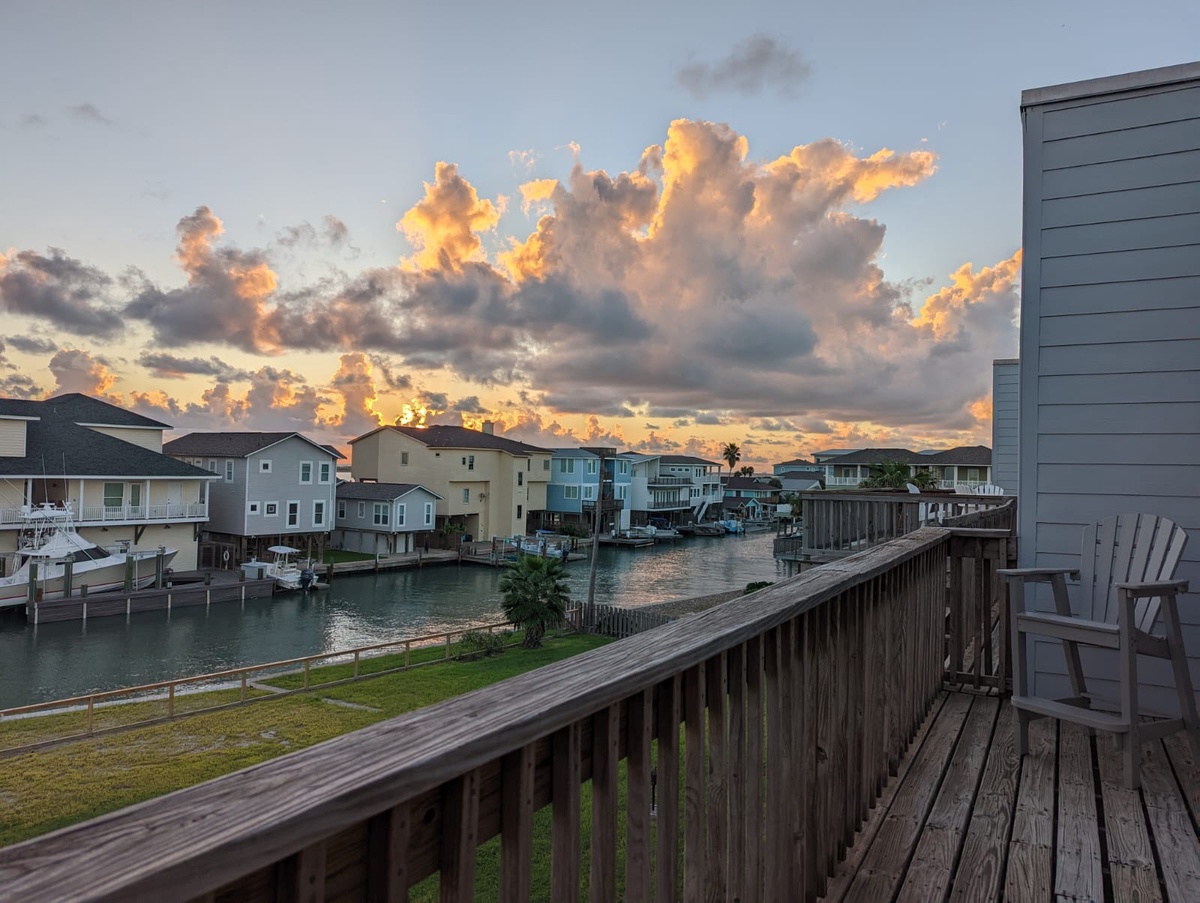 Stunning waterfront community with canal access and dramatic evening skies creates a picturesque coastal setting.