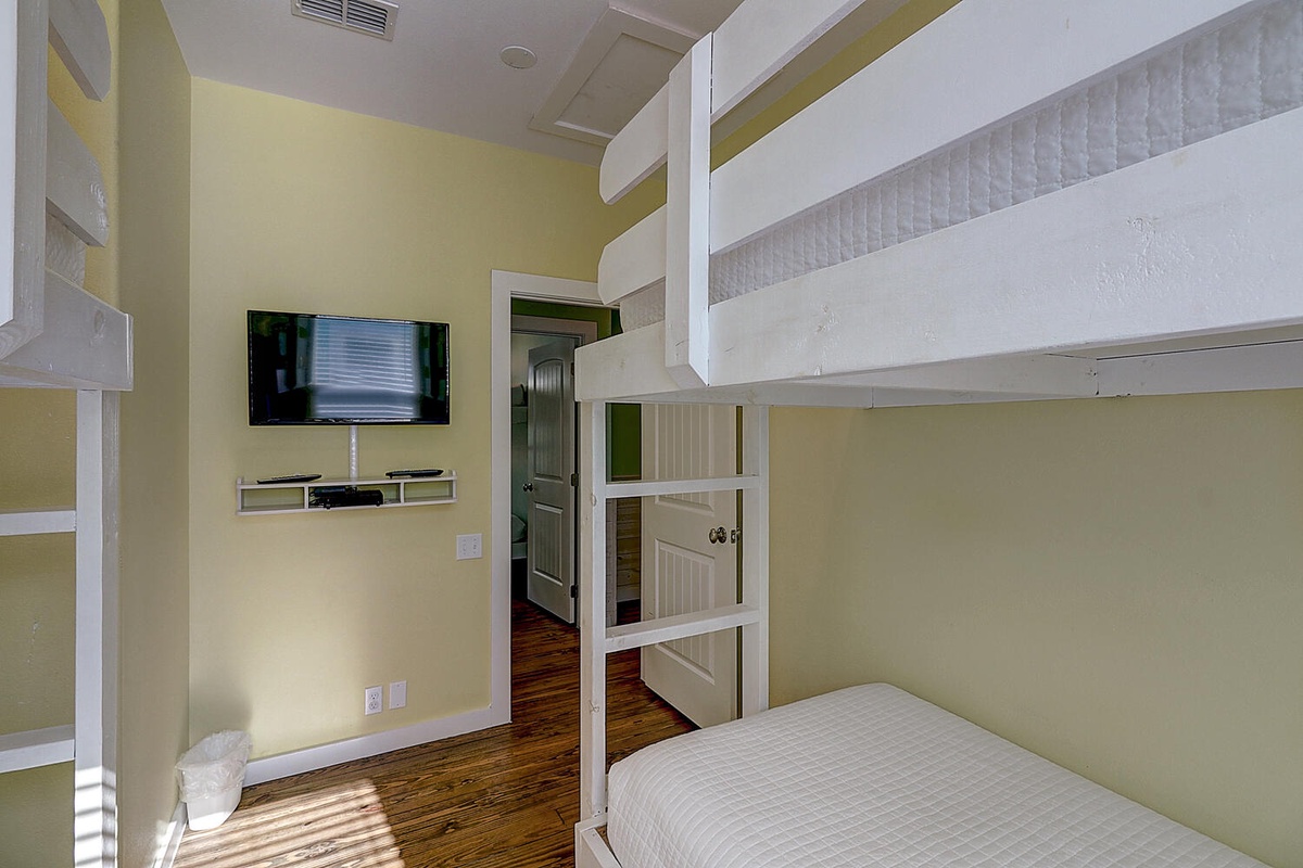 Sleep peacefully in your cozy bunk bed room, complete with personal TV and charming green accents.