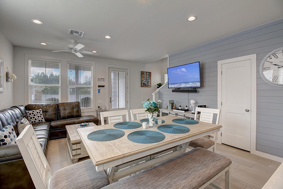 Gather around your spacious dining table for memorable meals, with comfortable seating and entertainment at your fingertips in this bright, coastal-inspired space.