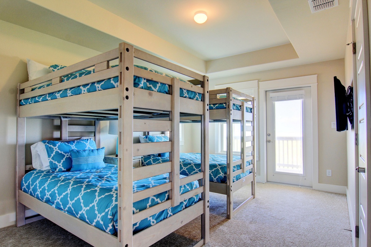 Cheerful bunk beds with vibrant blue bedding create the perfect space for your group to rest and recharge together.