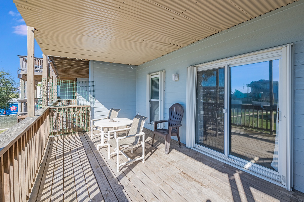 Relax on your private covered deck with comfortable seating and sliding glass doors opening to your coastal retreat.
