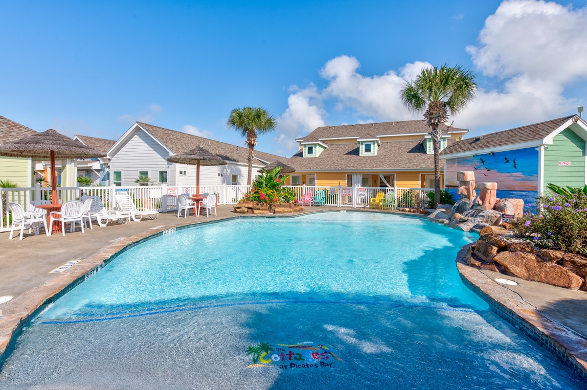 Dive into crystal-clear waters surrounded by colorful beach cottages and swaying palms, where your perfect poolside retreat awaits.