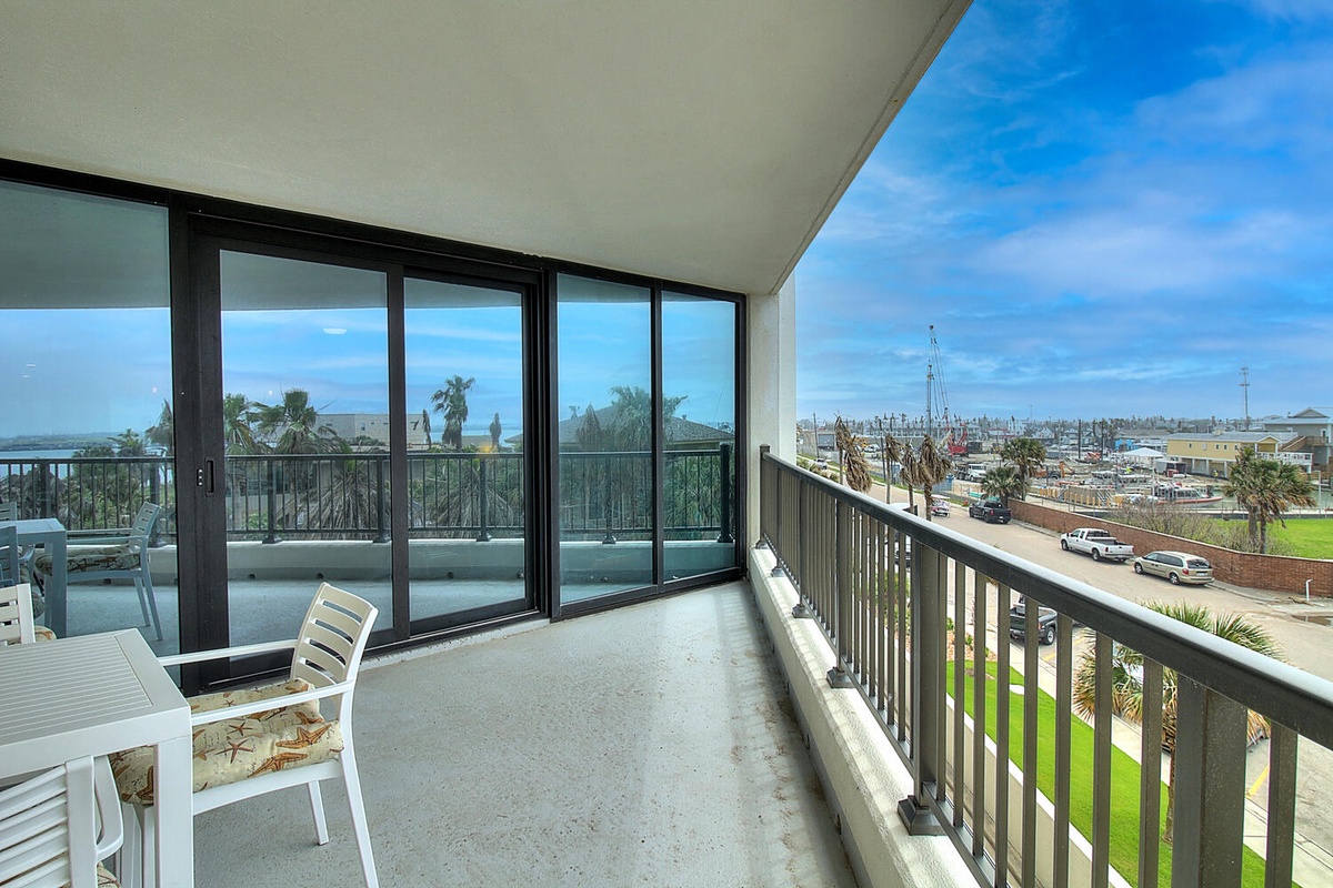 Step onto your private balcony where morning coffee tastes better with sweeping views of palm trees, marina, and endless blue sky.