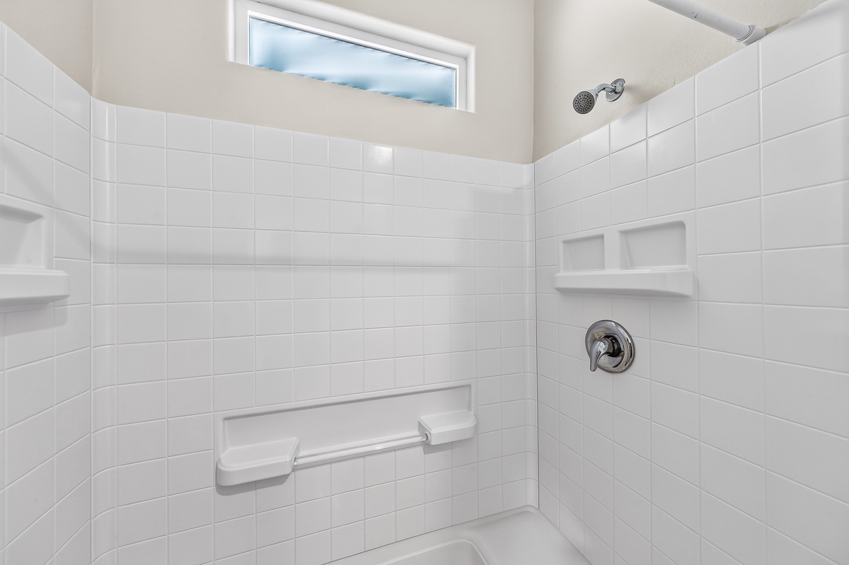 Enjoy the convenience of your private bathroom, complete with a tiled tub and shower combination.