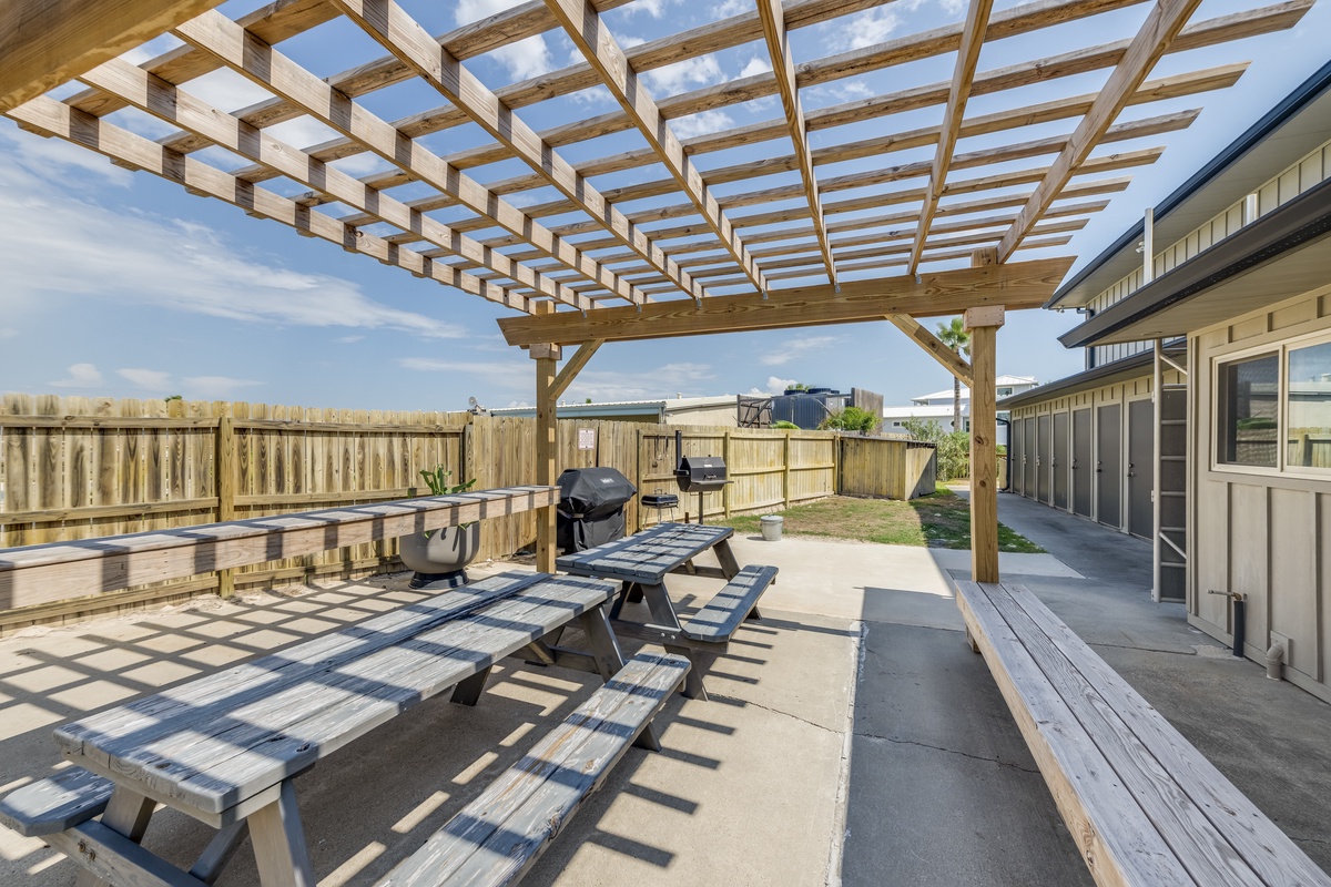 Gather with your group under this beautiful wooden pergola for outdoor dining and barbecue gatherings in your private backyard oasis.
