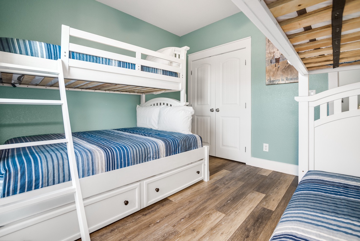 Your coastal-themed bunk room sleeps the whole crew with cheerful blue stripes and plenty of space to spread out.