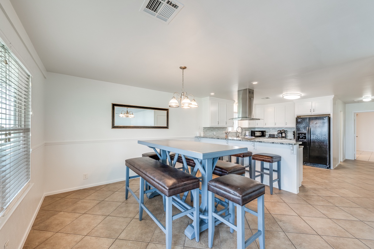You'll love gathering around this bright kitchen island with stylish blue seating, perfect for morning coffee or casual meals.