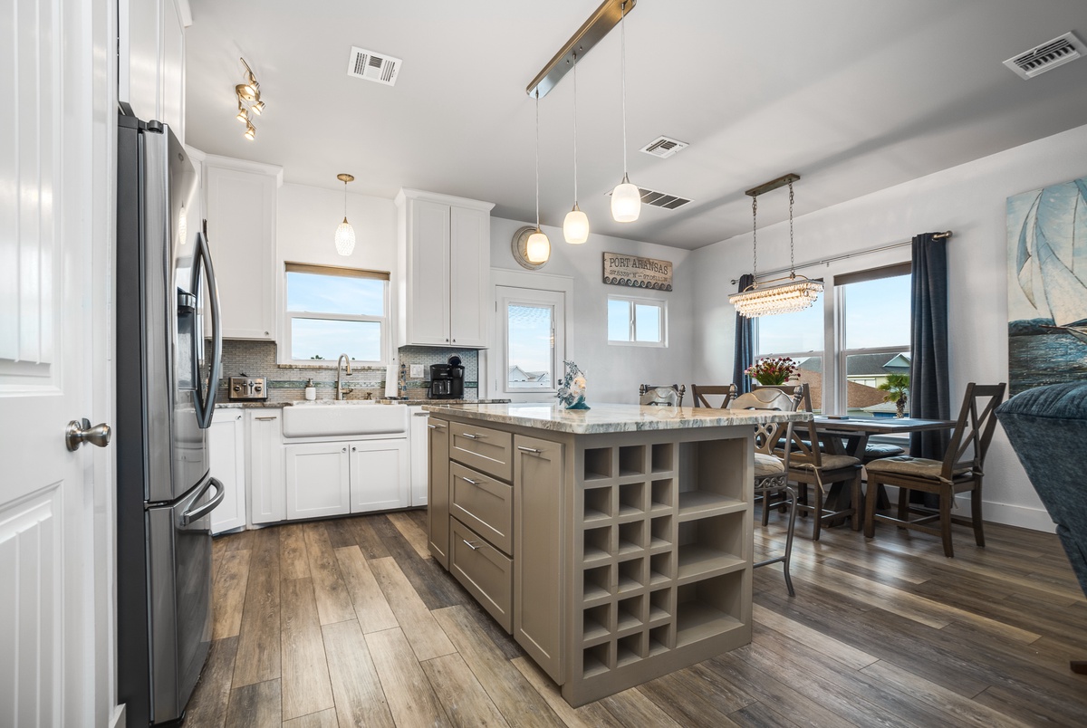 Your spacious kitchen invites culinary adventures with gleaming appliances, abundant storage, and a welcoming island perfect for morning coffee or evening conversations.