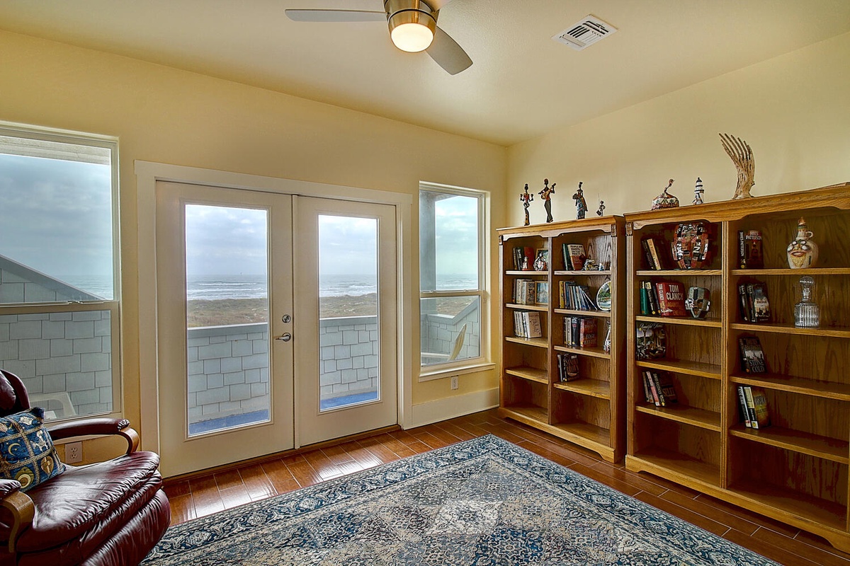 Curl up with a good book from your personal library while enjoying ocean views through French doors.