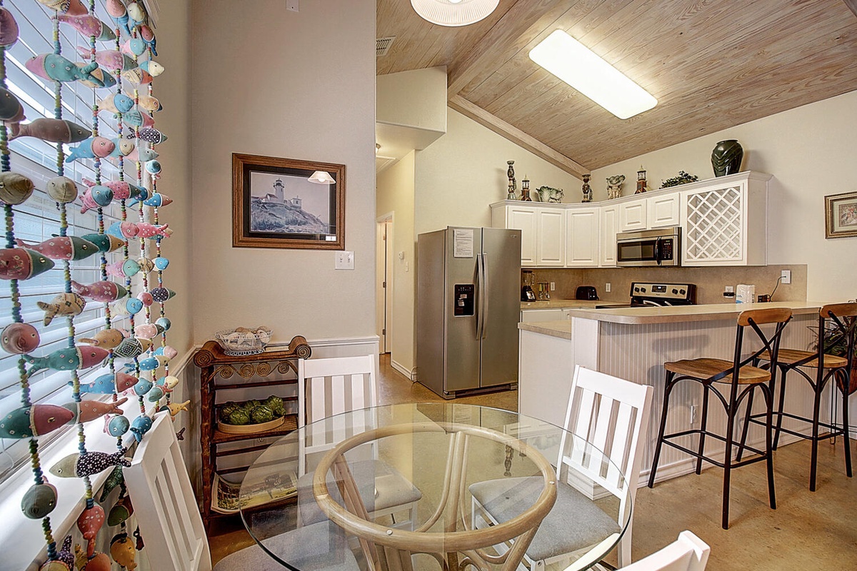 Your open-concept kitchen and dining space blends modern comfort with charming coastal touches, perfect for cooking memorable meals.