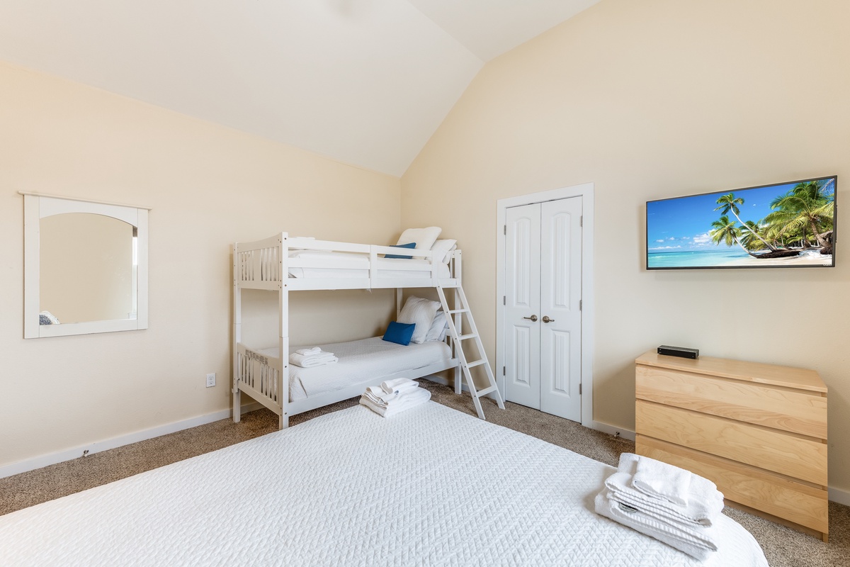 Relax in your bright, family-friendly bedroom featuring both comfortable beds and fun bunk beds for the kids.