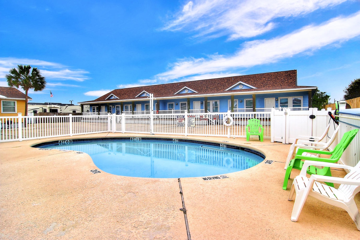 Dive into your private oasis with this sparkling pool surrounded by comfortable lounge chairs, perfect for soaking up the sun.