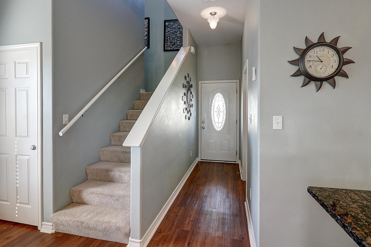 Step into your welcoming entrance where warm hardwood floors and soft lighting create the perfect first impression of your home away from home.